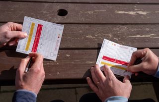 Players filling in scorecards