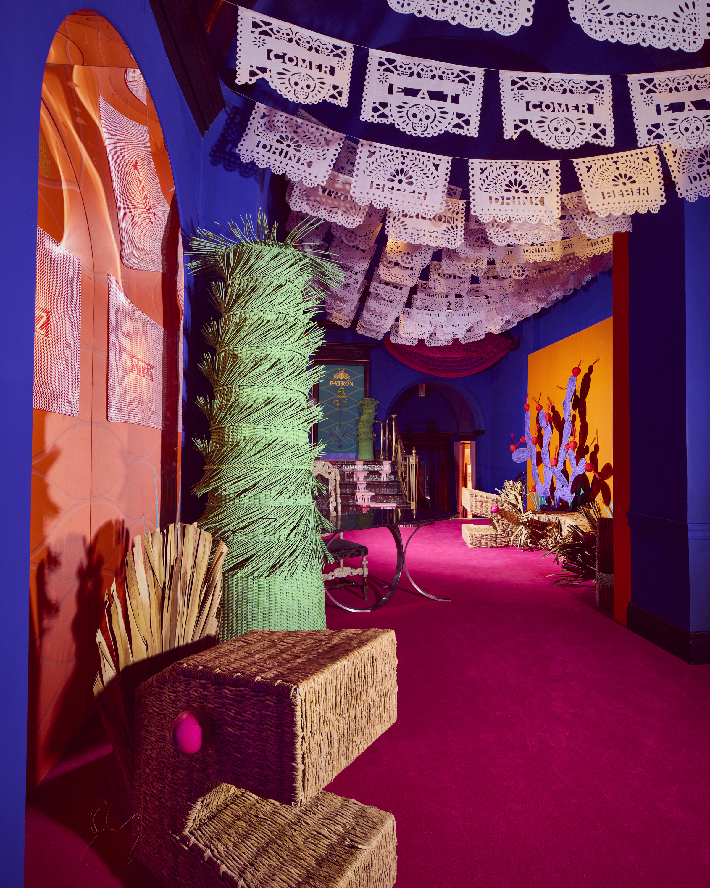 Installation view of ¡hola, London!, a whimsical art installation made of whicker-made furniture molded after dragons, cacti, and fantastical creatures, at sketch London.