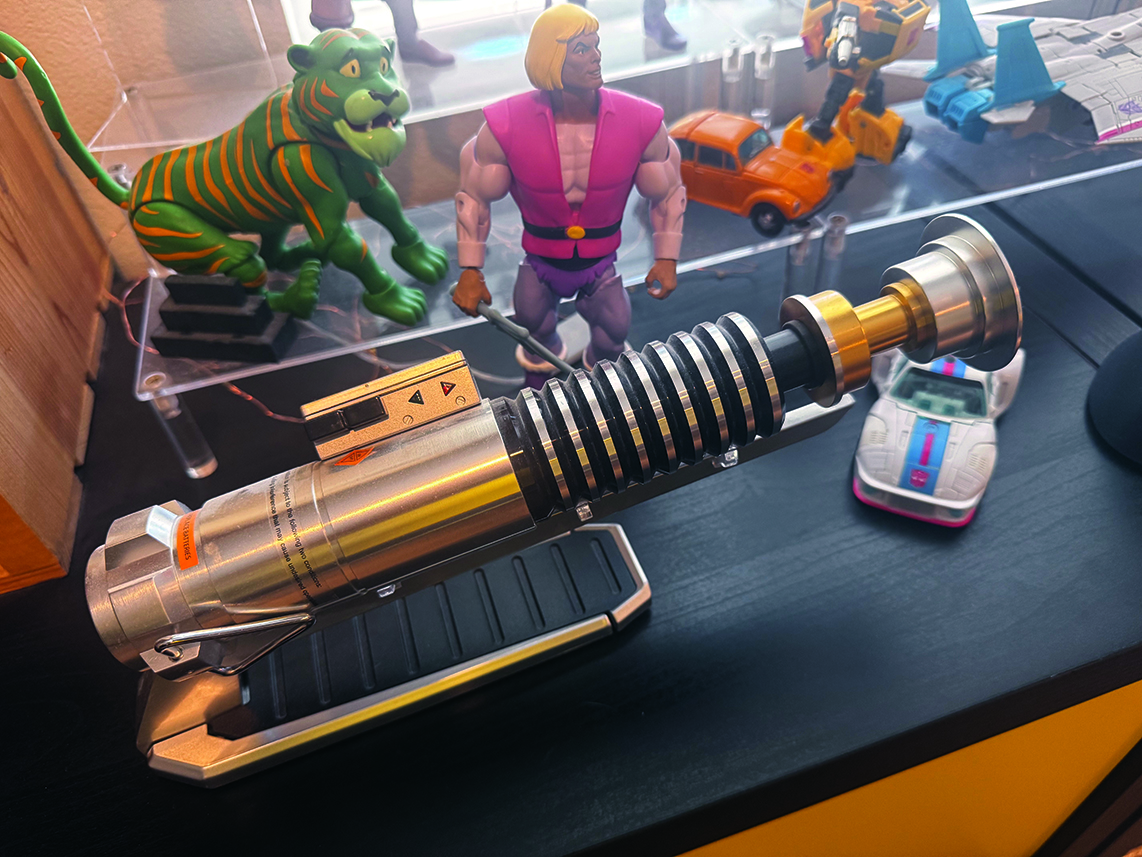 A replica lightsaber on a desk