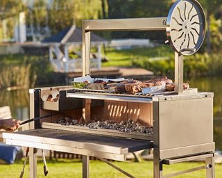 Outdoor grill station with cooking meats.