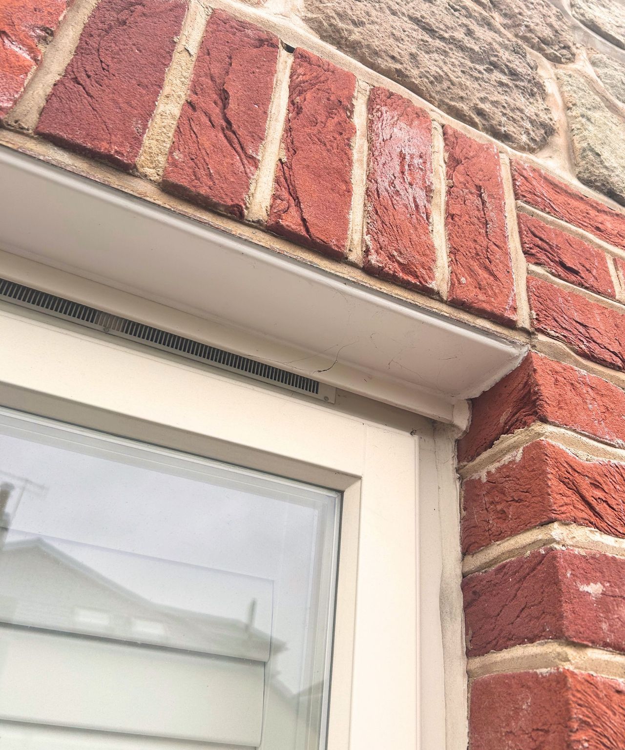 Before image of window with cobwebs