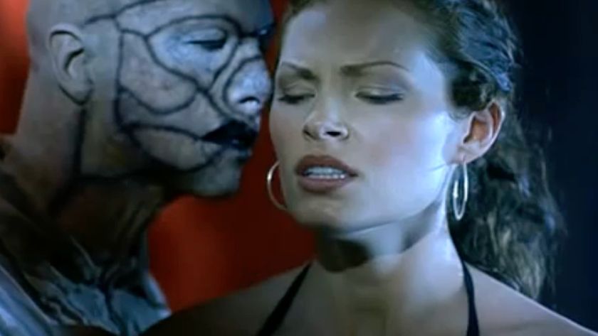 A zombie trying to get in the face of a human