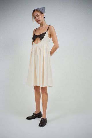 long white dress with black exposed bra