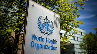 A picture taken on May 8, 2021 shows a sign of the World Health Organization (WHO) at the entrance of their headquarters in Geneva