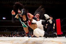 Wrestlers Kris Wolf and Starfire fight during their Stardom professional wrestling show