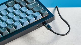 A black and blue Keychron Q7 wired mechanical keyboard that's made of metal