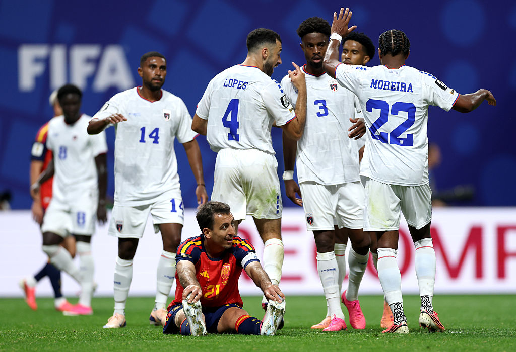 Mikel Oyarzabal stretches as Pico Lopes speaks with teammates during the FIFA World Cup 2026 Group H match between Spain and Cabo Verde.