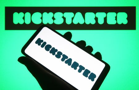 In this photo illustration, a Kickstarter, PBC logo is seen on a smartphone and on the background.