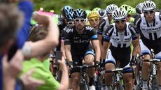Cyclists pass spectators during the Tour de France