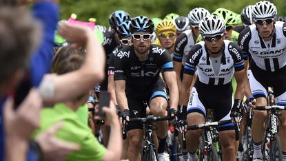 Cyclists pass spectators during the Tour de France