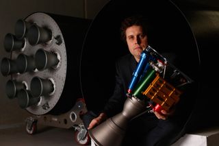 Rocket Lab CEO Peter Beck poses with The Rutherford rocket engine at the company's Auckland, New Zealand headquarters on June 10, 2015.