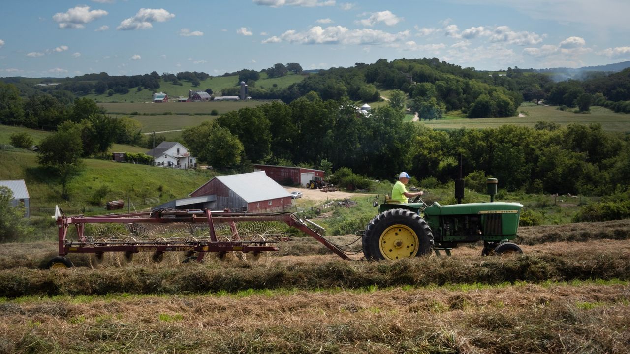 A view of a farmer on a tractor on a farm in Elizabeth, Illinois, in August 2024.