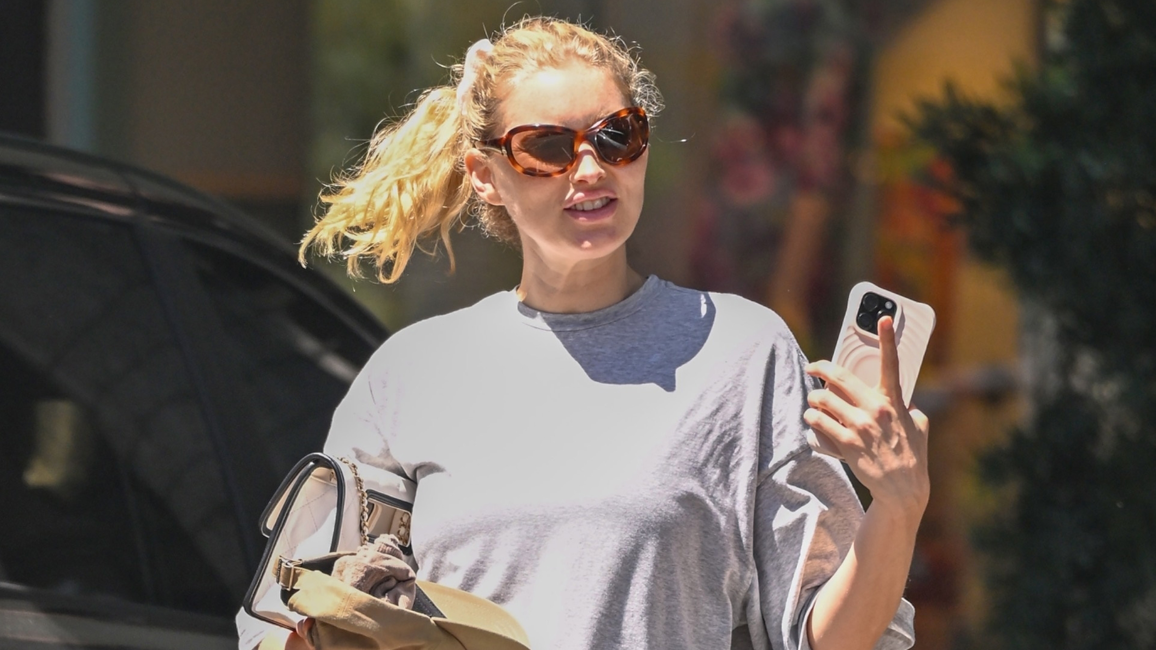 Elsa Hosk in Los Angeles heading to a Pilates class in an oversized T-shirt, tan leggings, and tan leather Chanel flip-flops. 