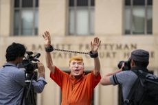 Protester dresses as Donald Trump before D.C. arraignment