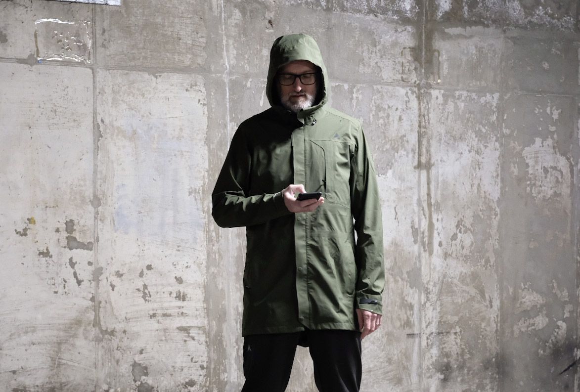Man on phone wearing Altura Grid Parka