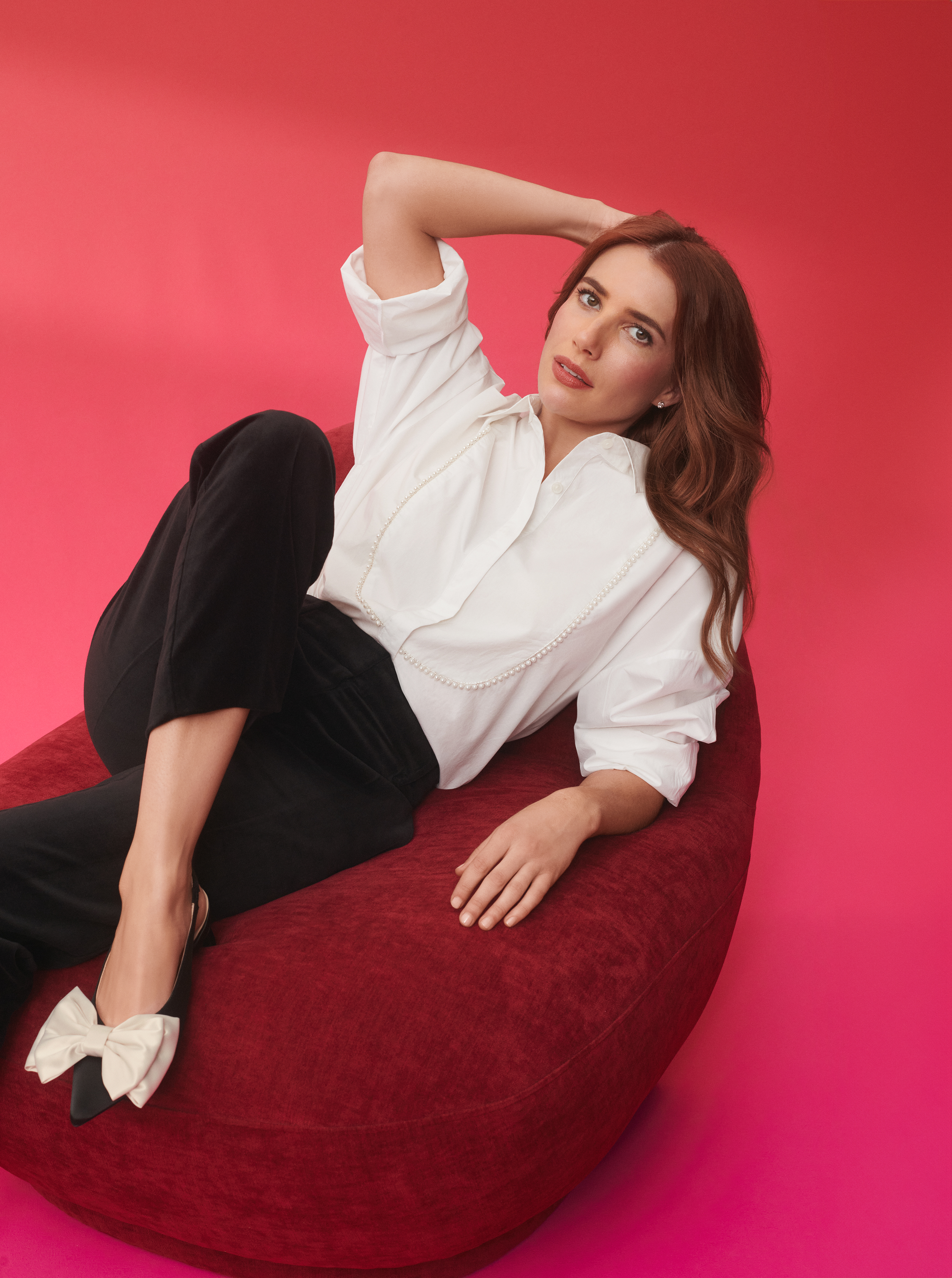 Emma Roberts in white shirts and velvet pants.