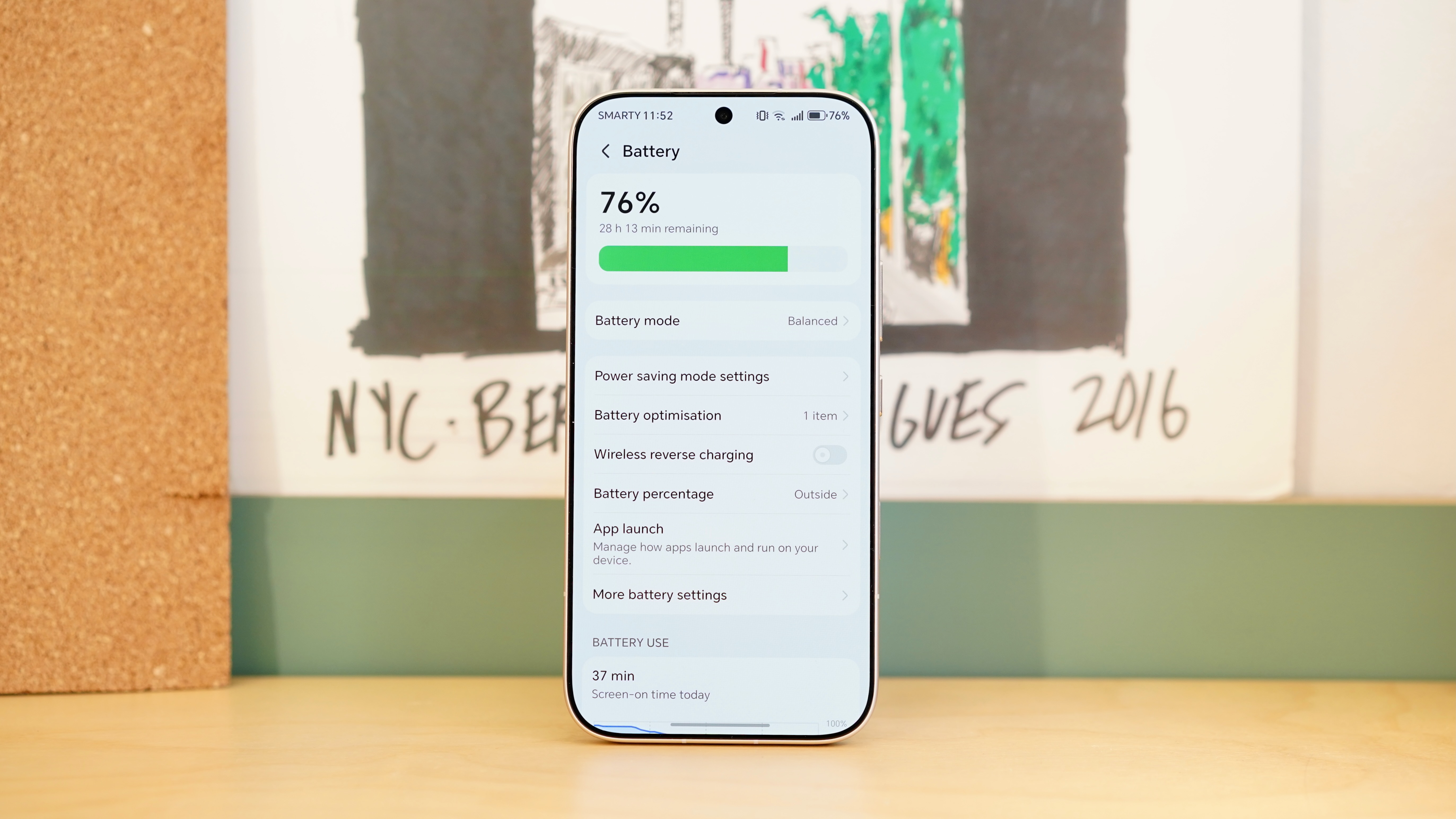 A white Honor 600 Pro resting on a wooden table