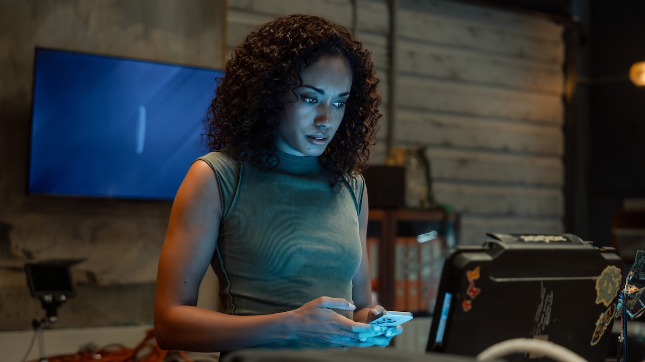 Michelle Mackey transferring information to her phone in the NCIS: Sydney base