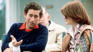 WINDSOR, ENGLAND - JULY: (EXACT DATE NOT KNOWN) Prince Charles, Prince of Wales, wearing a navy blue Ralph Lauren jumper, sits next to his girlfriend and sister of Lady Diana Spencer, Lady Sarah Spencer (later Lady Sarah McCorquodale) as they attend a polo match at Guards Polo Club in July, 1977 in Windsor, United Kingdom.