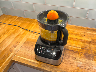 Image of orange being juiced in the Kenwood Multipro Onetouch citrus press