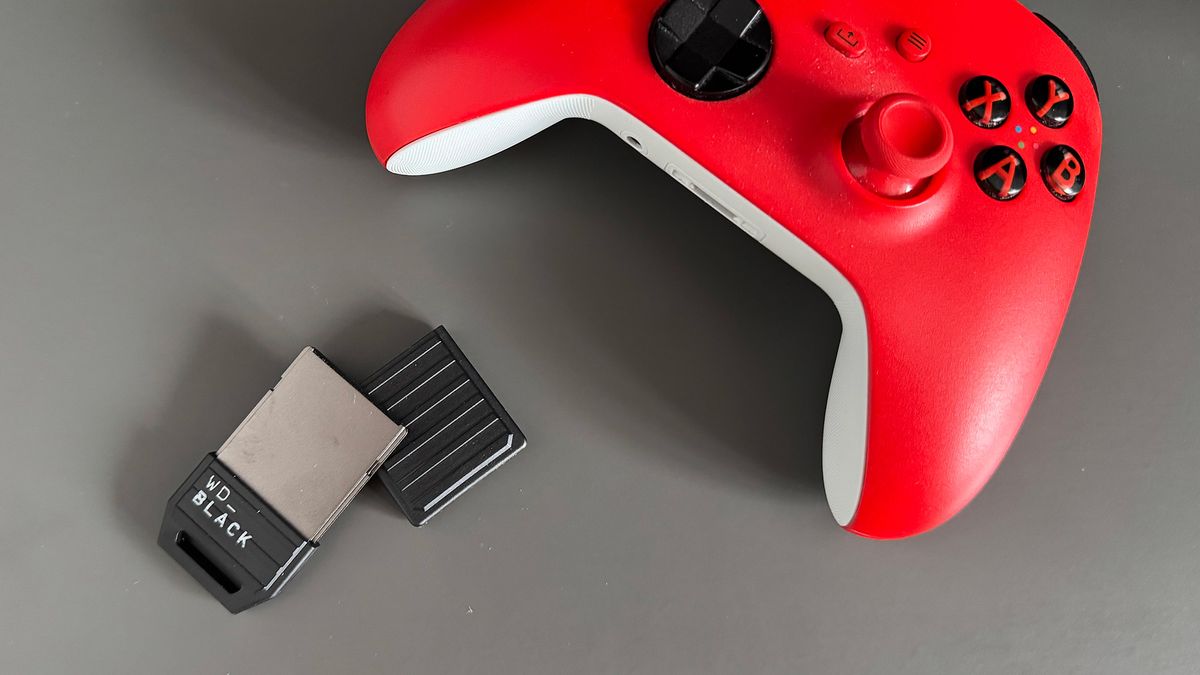 The WD Black C50 lying next to a red and white Xbox Series X controller
