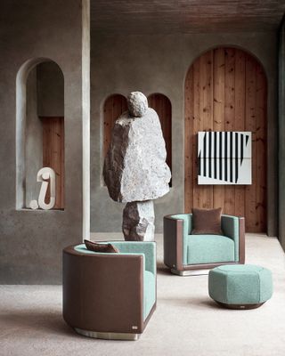House interior with abstract sculptures and two armchairs in green and brown