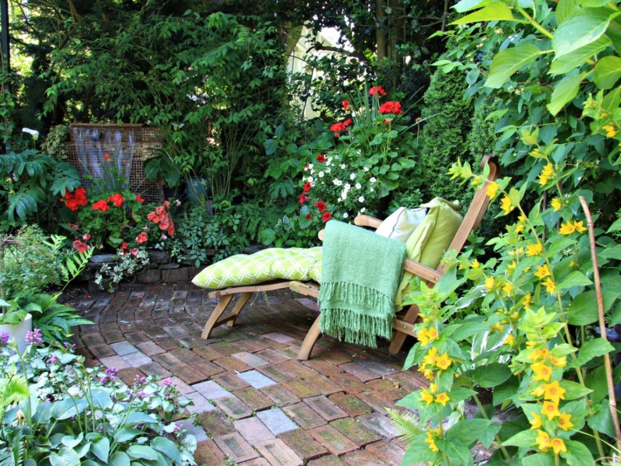 A comfortable lounge chair in a secluded corner of a beautiful garden