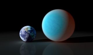 An artist's concept shows the size of super-Earth 55 Cancri e compared with Earth. A ground-based telescope in Spain was able to identify 55 Cancri e, which suggests that telescopes on the ground help in the search for habitable planets around other stars.