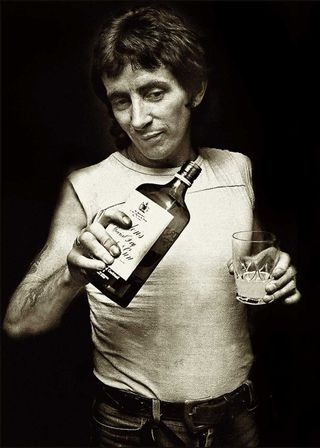 Bon Scott with a bottle of gin, 1976