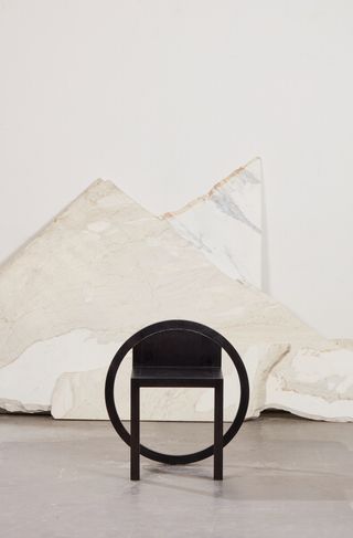 Black round chair by Paolo Pallucco