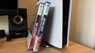 Astro Bot and Spider-Man 2 PS5 games leaning against PS5 Pro console