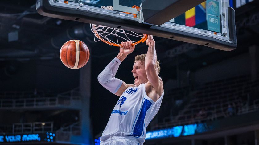 Lauri Markkanen of Finland hangs on the rim in celebration after a thunderous dunk during the FIBA EuroBasket 2025 quarterfinal between Finland and Georgia at Arena Riga on September 10, 2025 in Riga, Latvia.