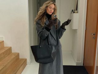 Anouk Yve in a gray coat and black Jimmy Choo bag.