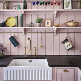 pink panelling behind butlers sink in kitchen