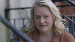 June smiling watching kids play in the Testaments Season 1 finale. 