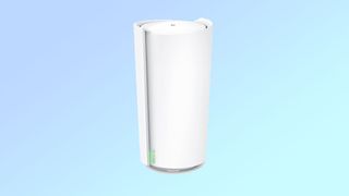 Product shot of the TP-Link Deco XE200 mesh router unit, a white tapered cylinder, on a blue background.
