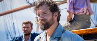 Henry Cavill looking rugged while he stands on a boat in The Ministry of Ungentlemanly Warfare.