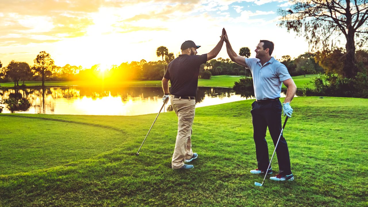 Golfers high five GettyImages-1353062822