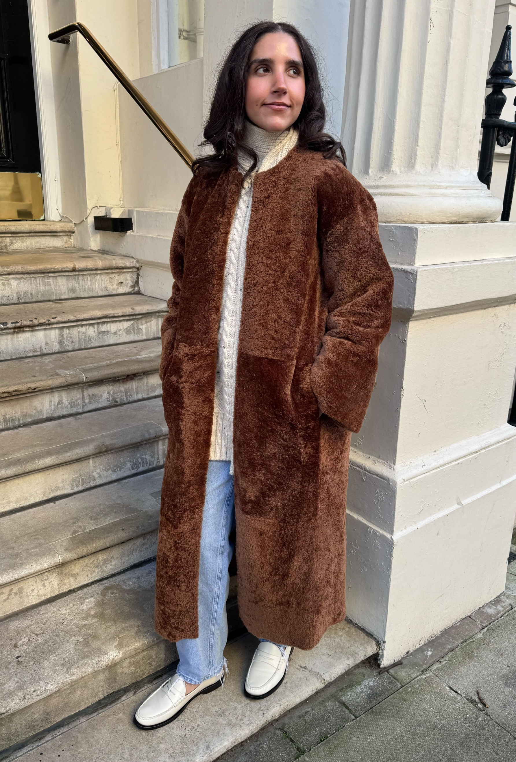 An editor from Who What Wear UK modelling a teddy coat.