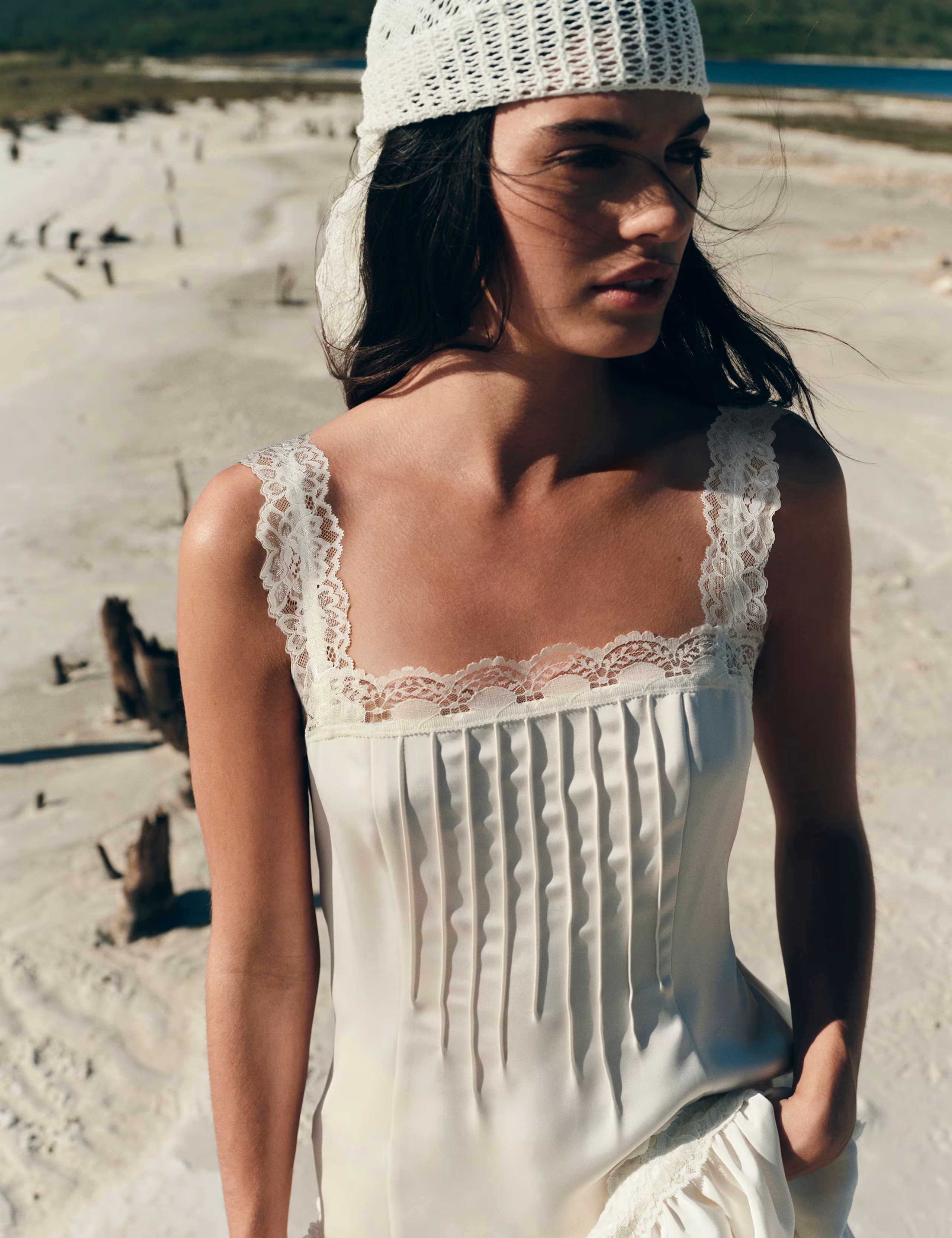 Model wears white bandana, white pleat from mini dress