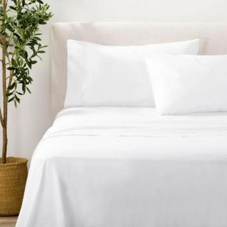 A bed with bright white sheets from Nate Home