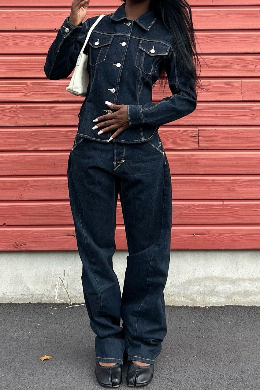 a woman wearing a denim jacket, jeans and tabi flats