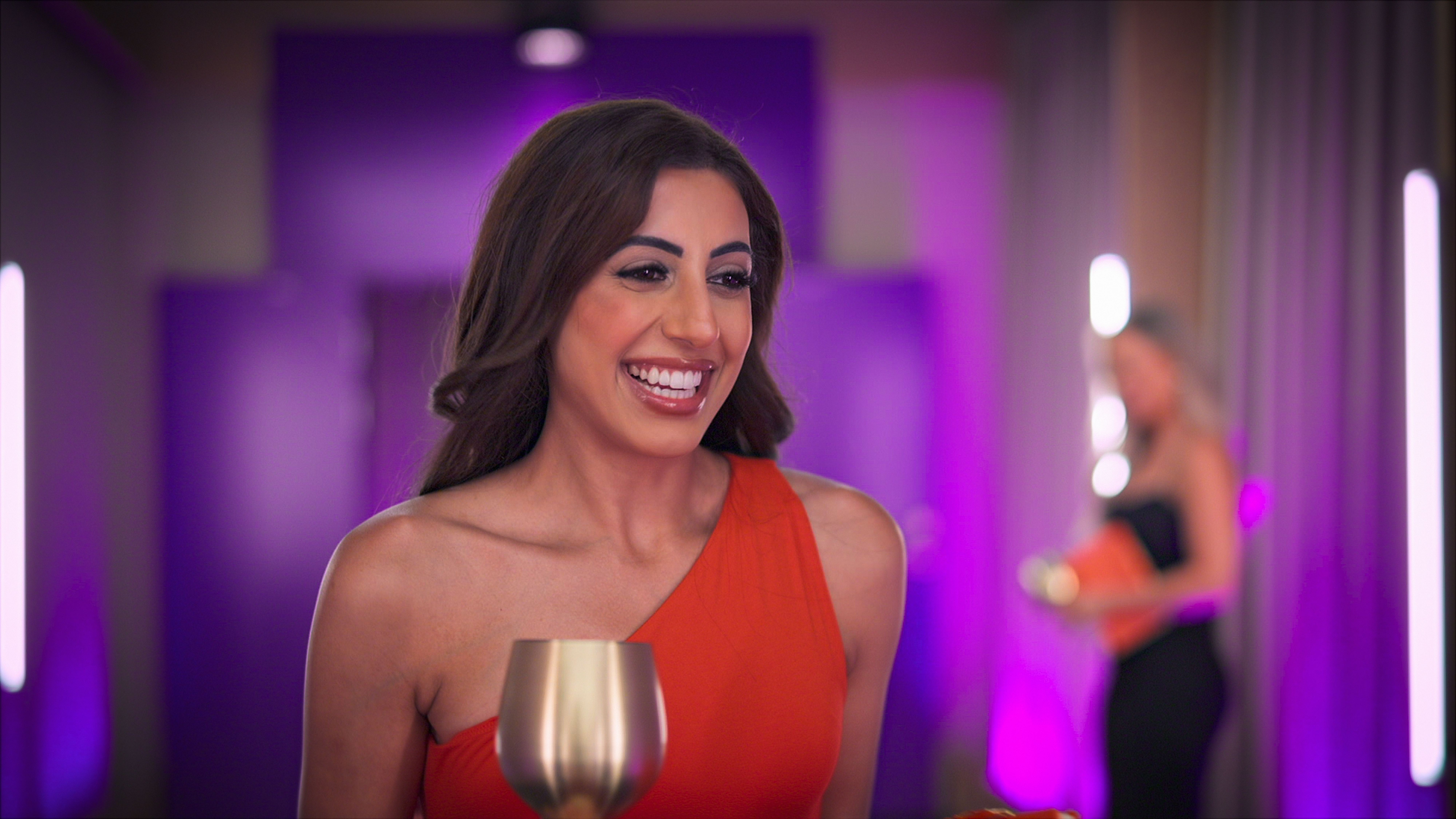 sarover smiles while holding a gold glass in the pods in love is blind uk season 2