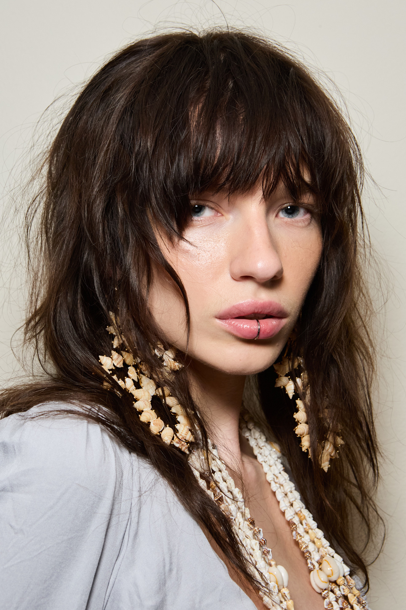 A model wearing their hair in a shag haircut.