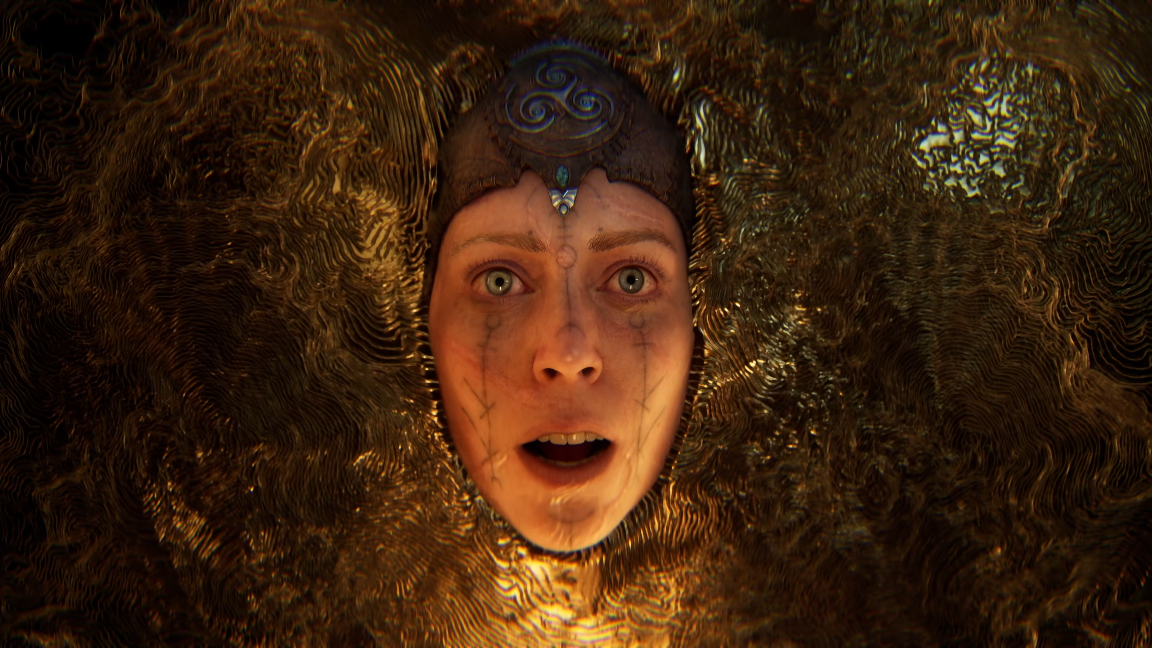 Senua submerged in a gold murk in Senua.
