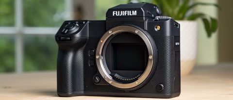 Fujifilm GFX100 II on a wooden table, front of the camera no lens attached