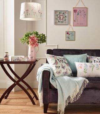 living room with pink flower vase hanging light and sofa