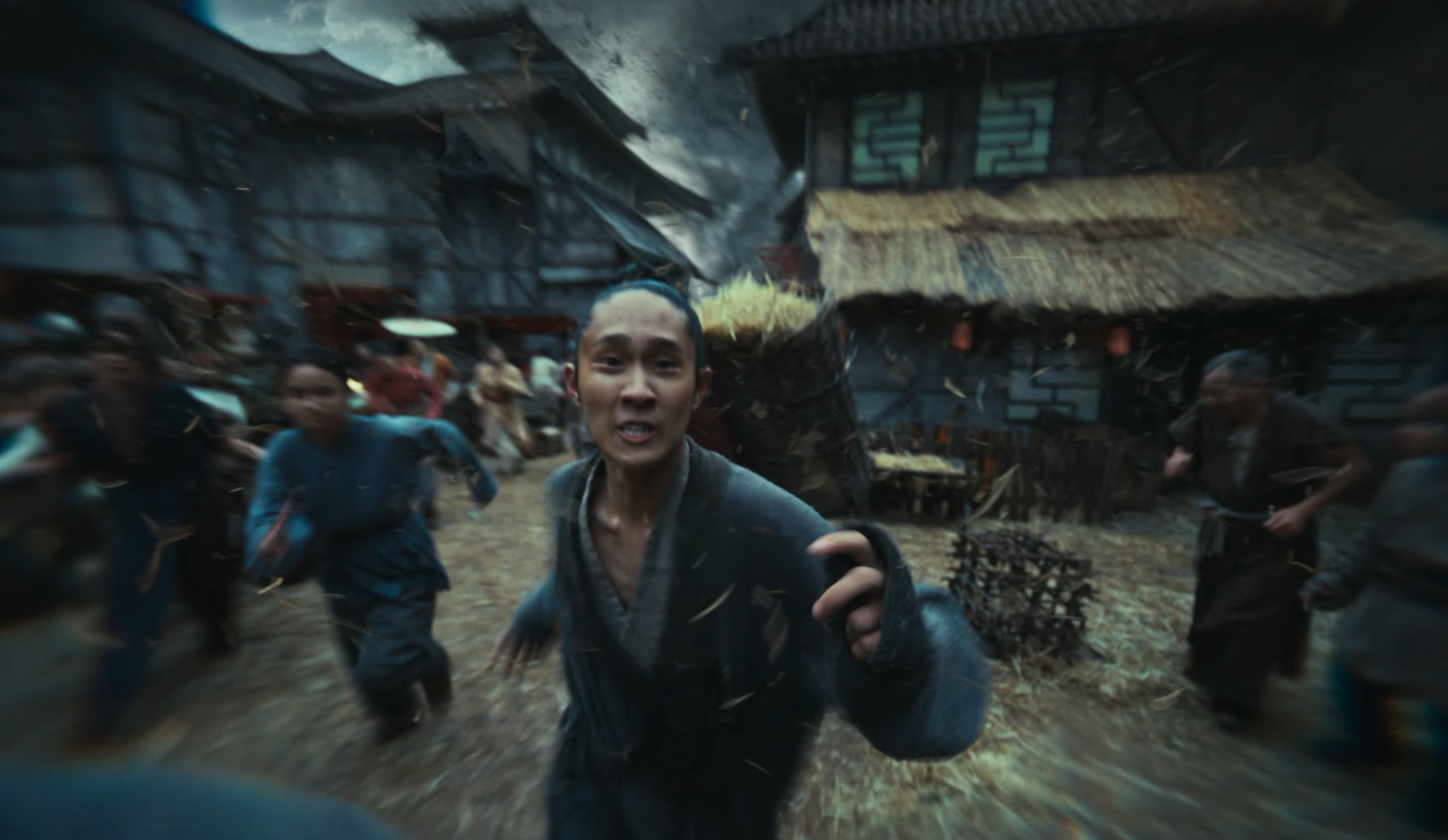 A still from the Humankind 2 reveal trailer showing a man running from a huge tornado.