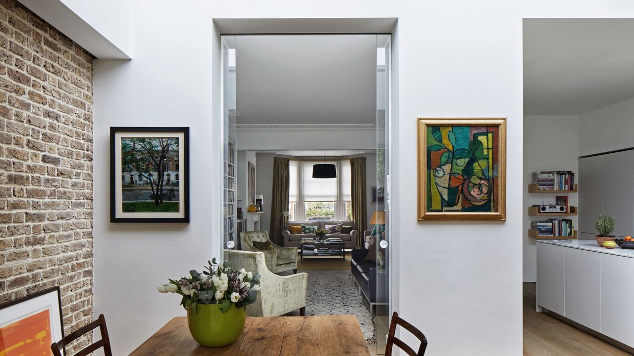 Glass pocket doors open between the kitchen and dining area and the living room