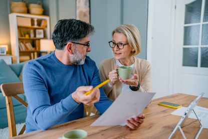A couple discussing their finances at a desk.